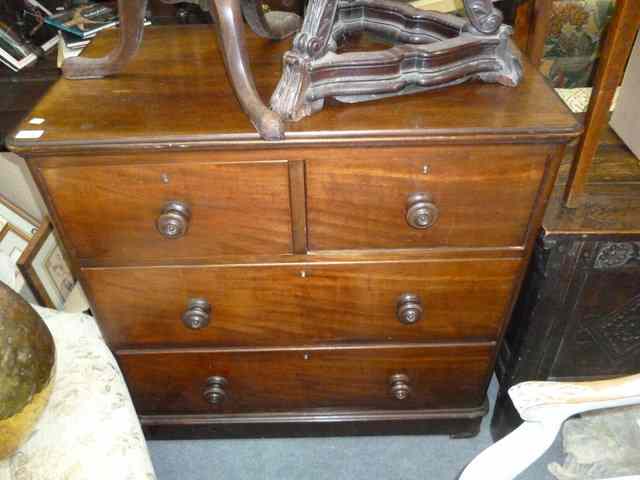 Appraisal: A SMALL VICTORIAN MAHOGANY CHEST of two short and two