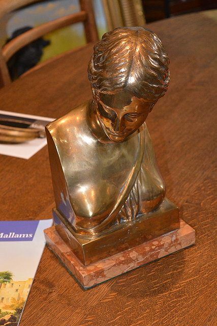 Appraisal: Bronze bust of a girlon a marble rectangular base circa