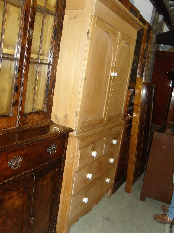 Appraisal: A continental stripped and waxed pine linen press the upper