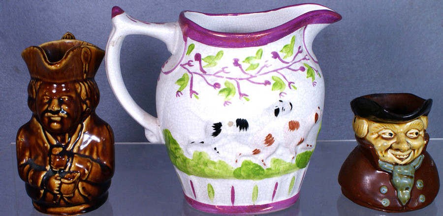 Appraisal: Pink luster pitcher with embossed dog h with a Rockingham