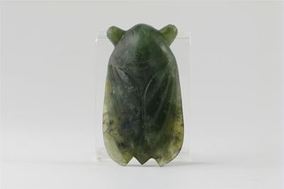 Appraisal: A Chinese spinach jade model of a cicada with protuberant