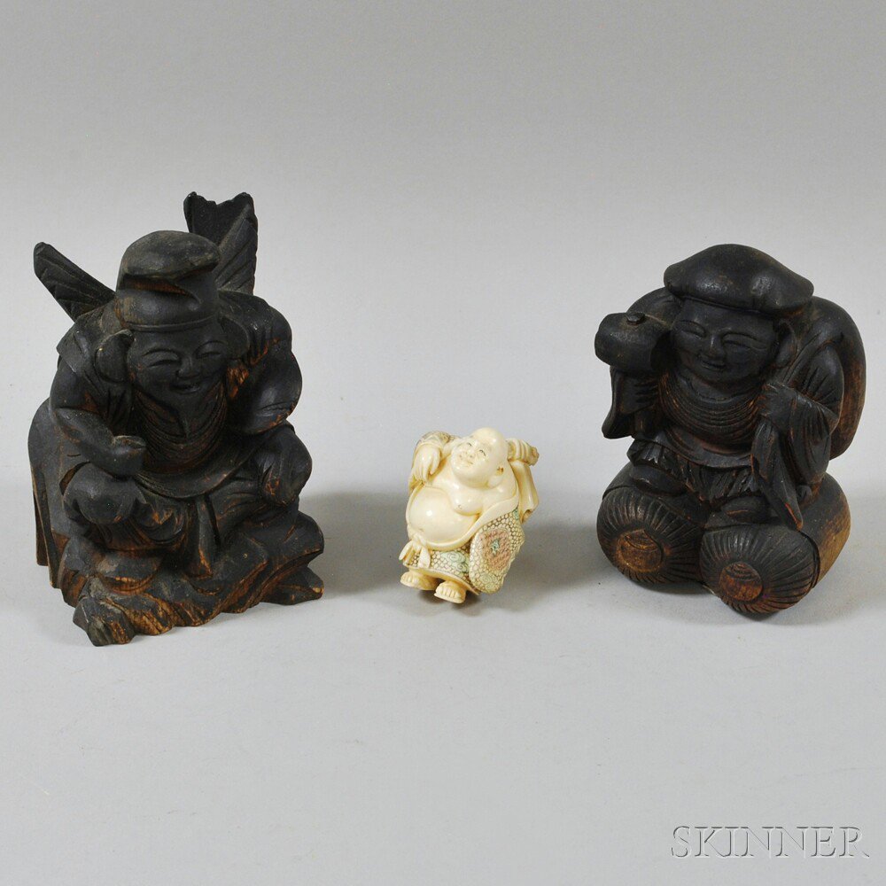 Appraisal: Three Pottery and Carved Figures a seated Ebizu with fish