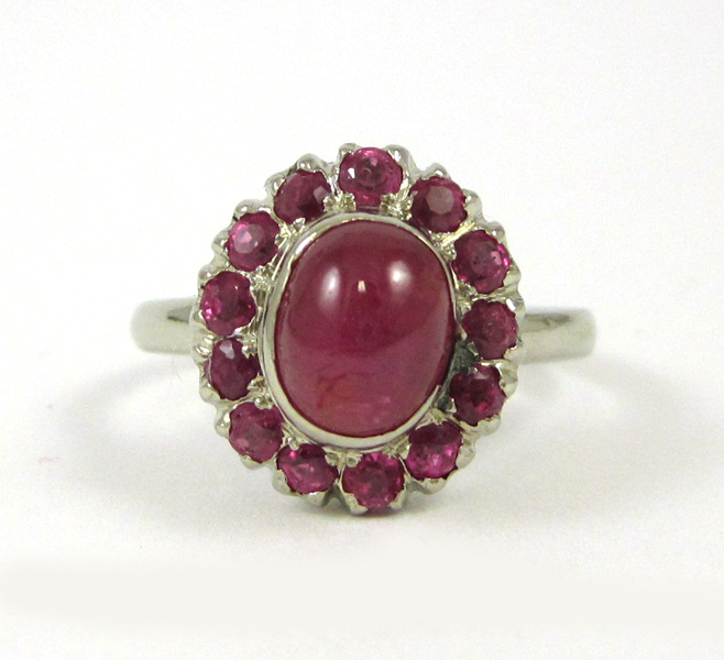 Appraisal: RUBY AND FOURTEEN KARAT WHITE GOLD RING with round-cut diamonds