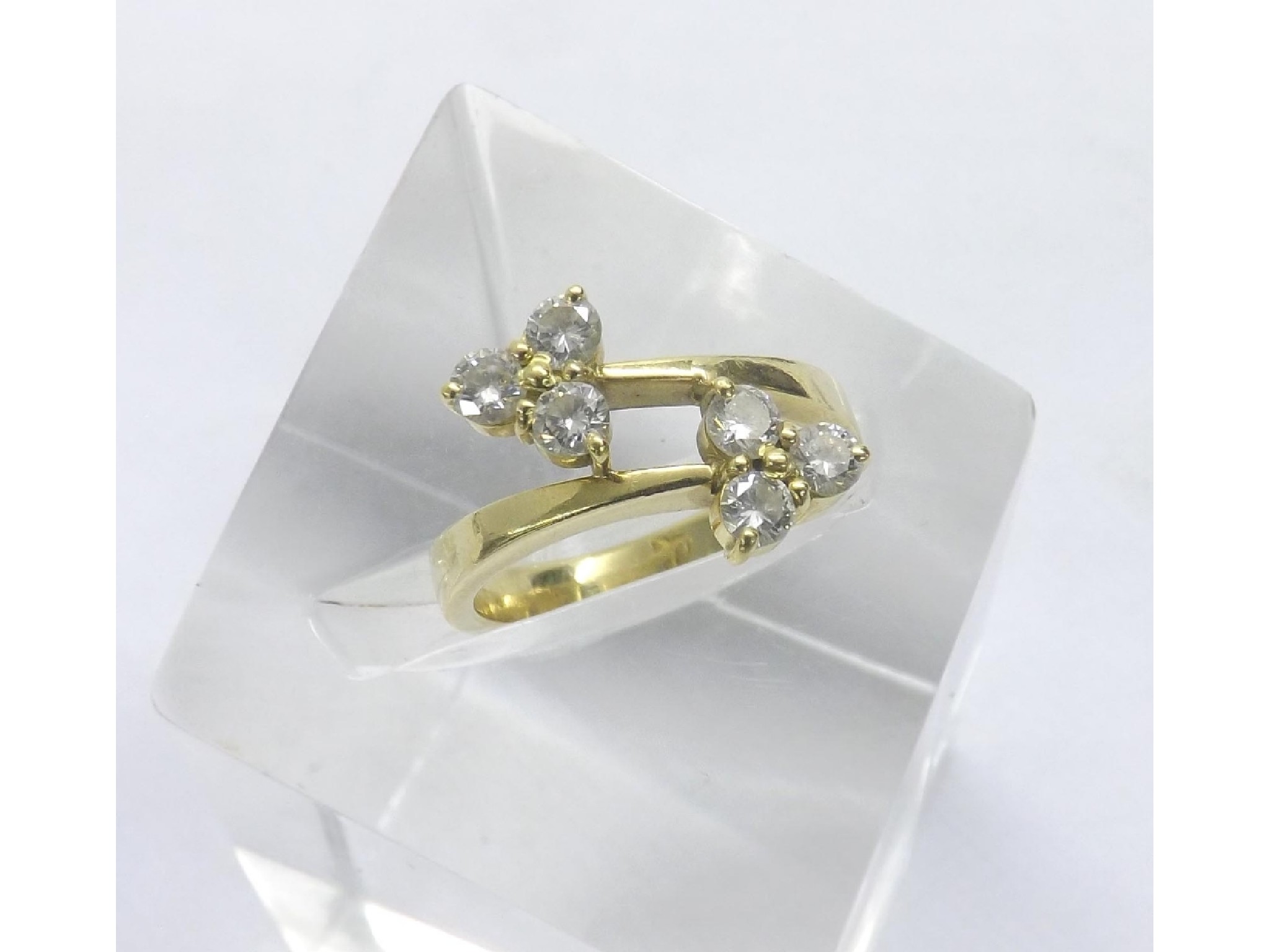 Appraisal: - -a Six stone diamond crossover ring in yellow gold