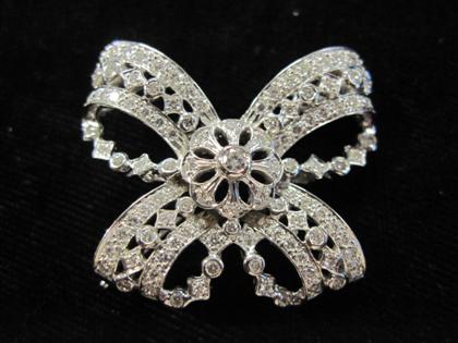 Appraisal: karat white gold and diamond bow broochOne hundred and eight