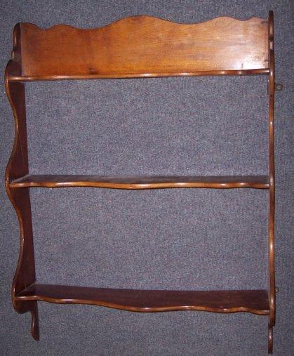 Appraisal: A Victorian mahogany set of hanging shelves on shaped supports