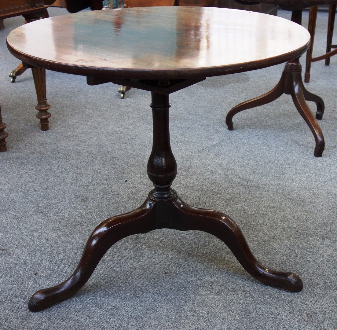 Appraisal: A mid th century mahogany occasional table the circular snap