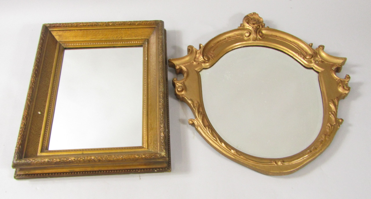 Appraisal: A thC shield shaped gilt wood wall mirror inset bevelled