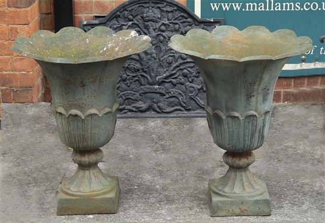 Appraisal: A PAIR OF VICTORIAN CAST IRON FLARED URNS each with