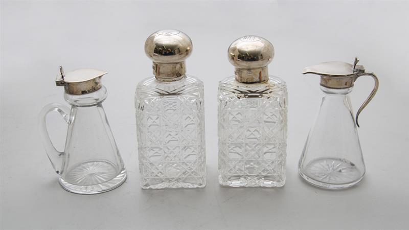 Appraisal: PAIR OF ENGLISH MONOGRAMMED SILVER-LIDDED CUT-GLASS SCENT BOTTLES AND TWO