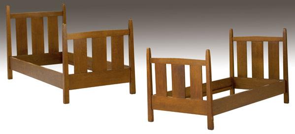 Appraisal: GUSTAV STICKLEY Pair of slatted twin beds with tapering posts