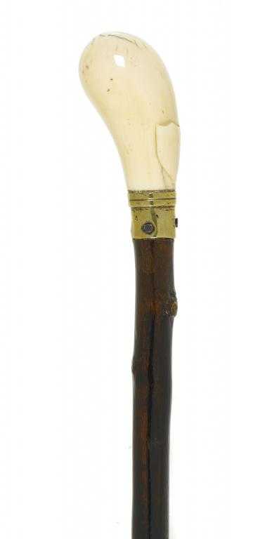 Appraisal: A BRIARWOOD CANE the bulbous ivory handle carved with a