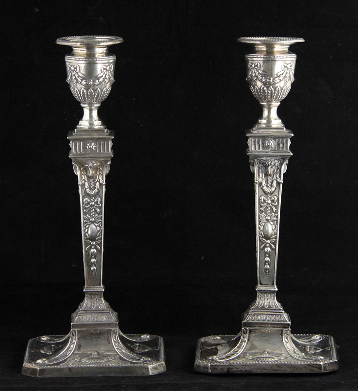 Appraisal: A pair of neoclassical style silver candlesticks RP London the