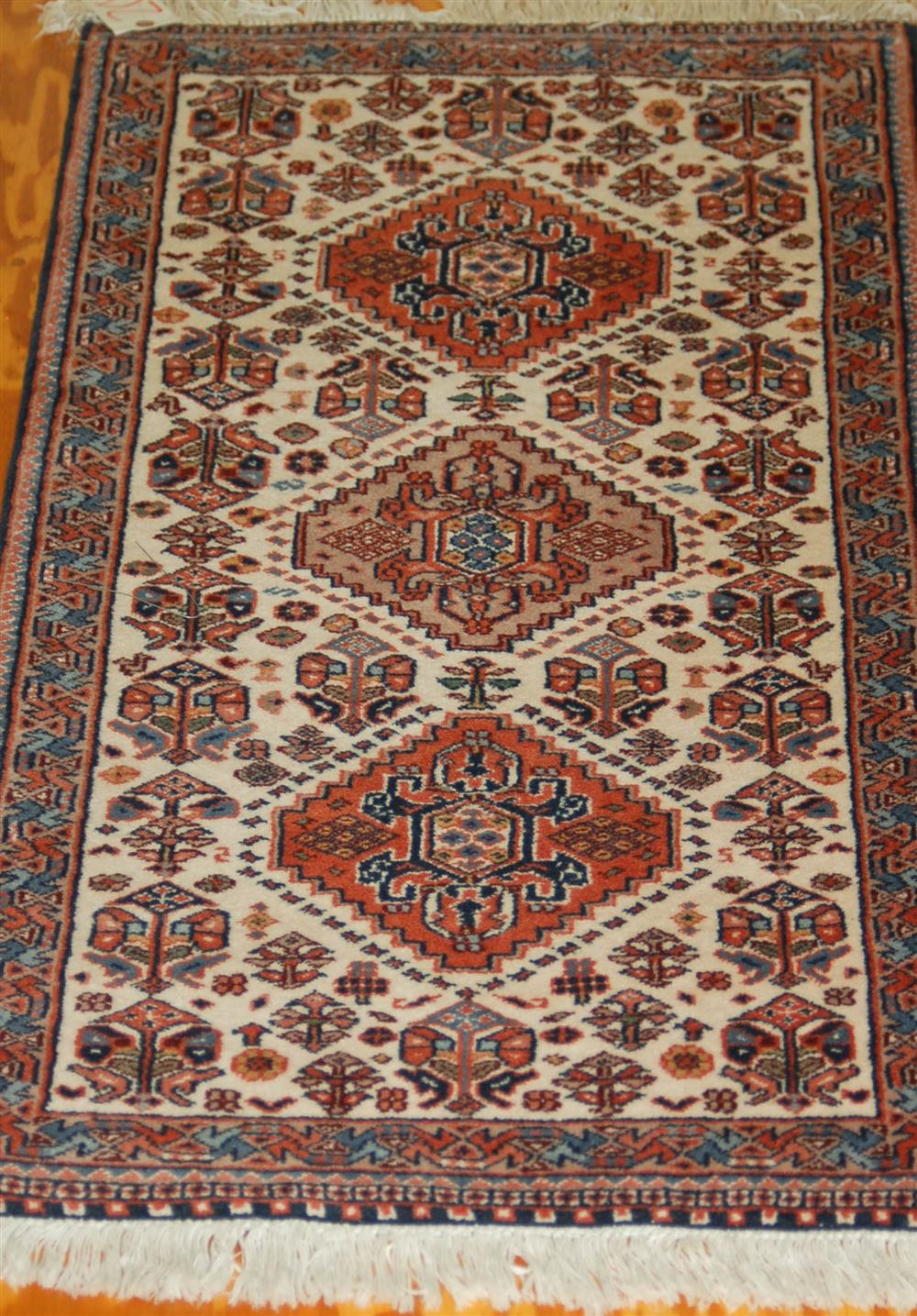 Appraisal: INDO PERSIAN HANDWOVEN WOOL RUG having three large Bokhara patterns