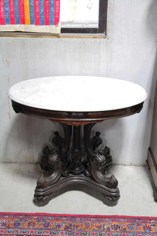 Appraisal: VICTORIAN PARLOR TABLE White and oval marble top resting on