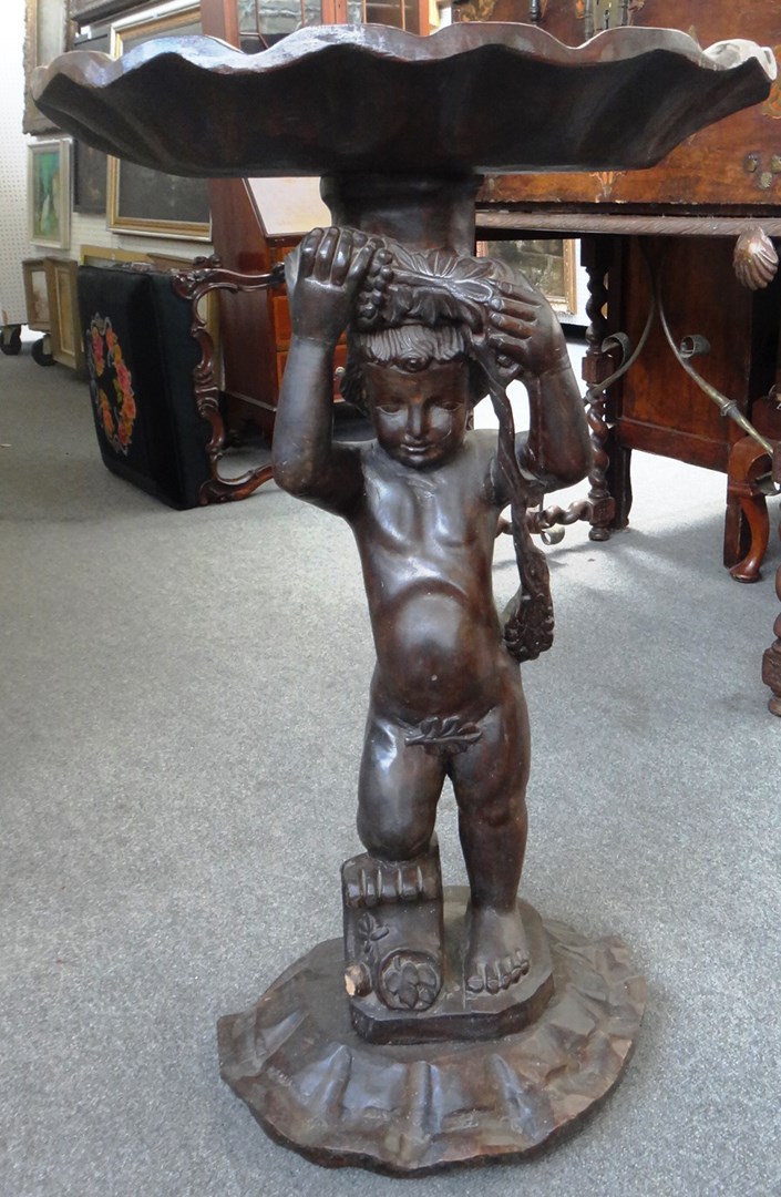 Appraisal: A th century carved walnut continental figure of a cherub