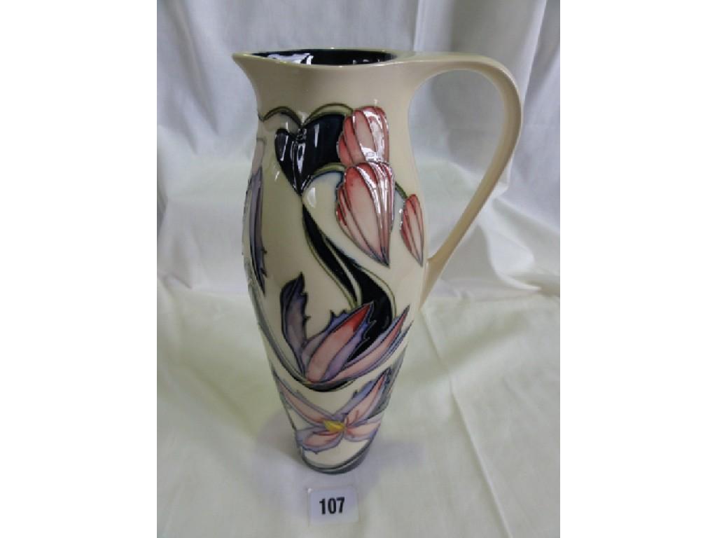 Appraisal: A Moorcroft Pottery tall cream ground ewer with painted and