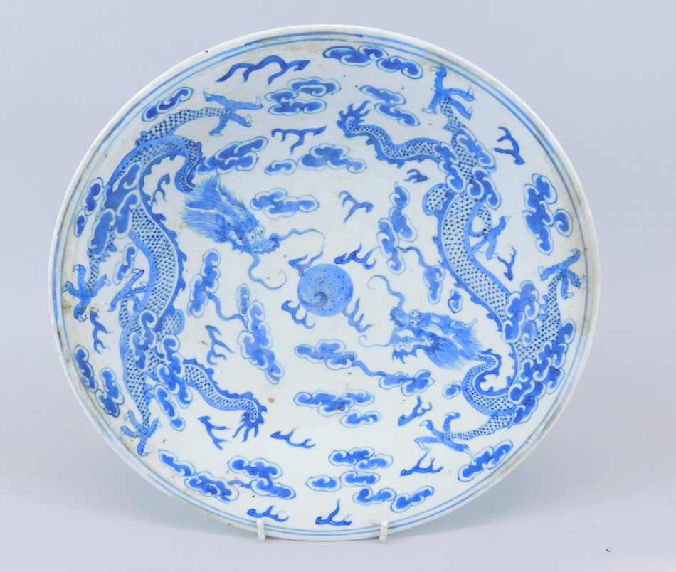 Appraisal: An oriental blue and white small saucer dish decorated with