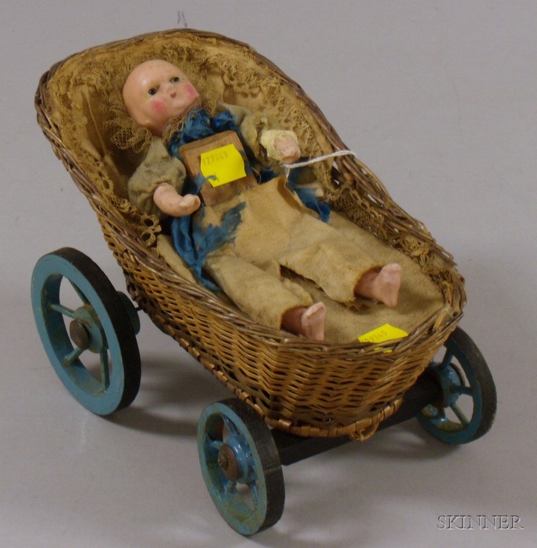 Appraisal: Small Mechanical Wax Head Doll in Basketry Carriage with Painted