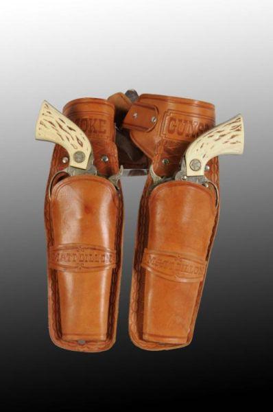 Appraisal: Western Gunsmoke Double Toy Cap Gun Holster Set Description Holster