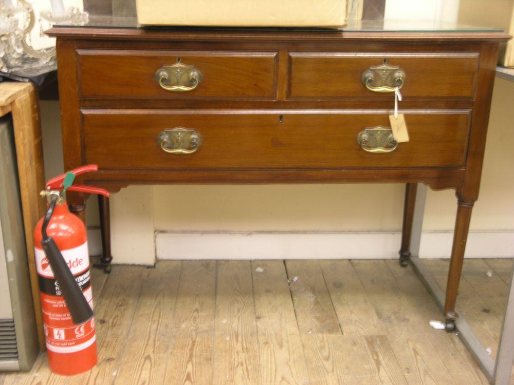 Appraisal: A mahogany dressing chest one long and two short drawers