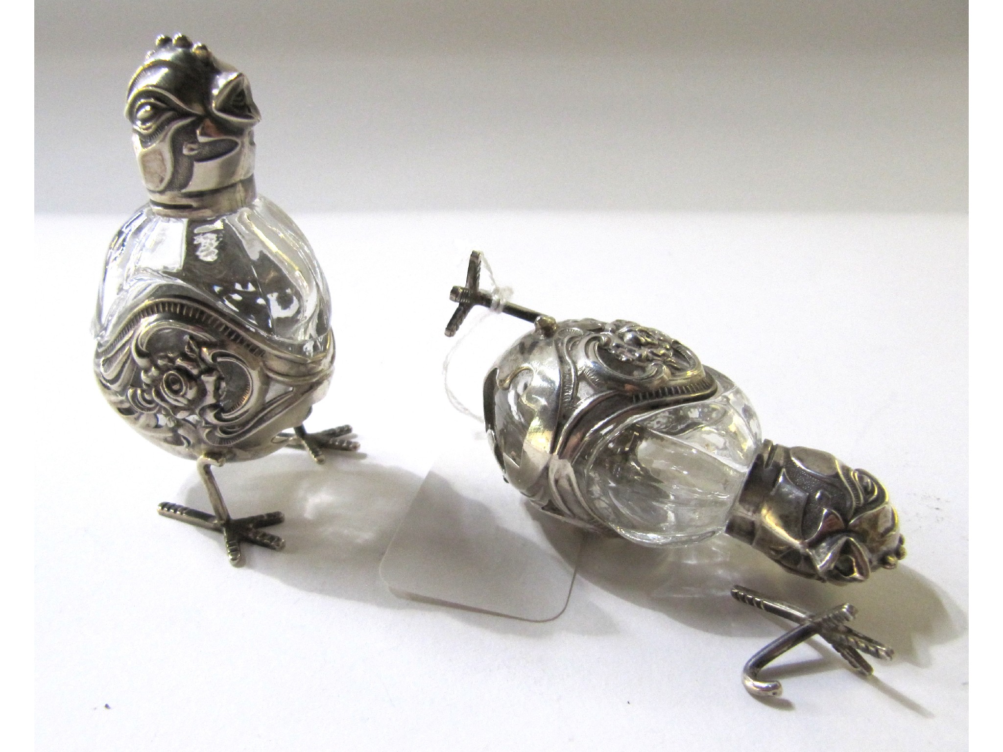 Appraisal: A pair of novelty white metal and cut glass salts