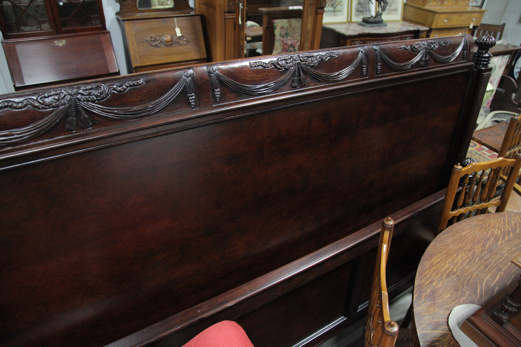 Appraisal: CONTEMPORARY BED American mahogany bed with carved swag and tassel