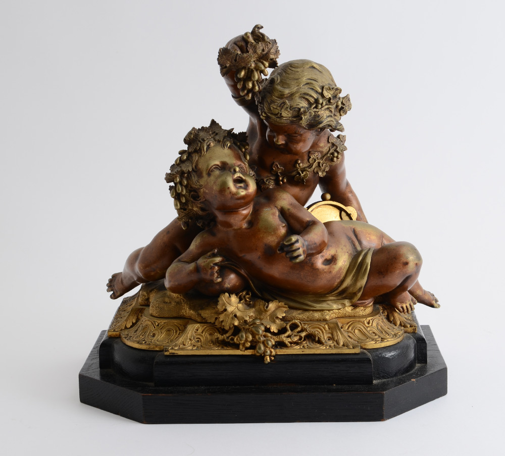 Appraisal: BACCHANALIAN BRONZE PUTTI GROUP Feasting on grapes are a pair