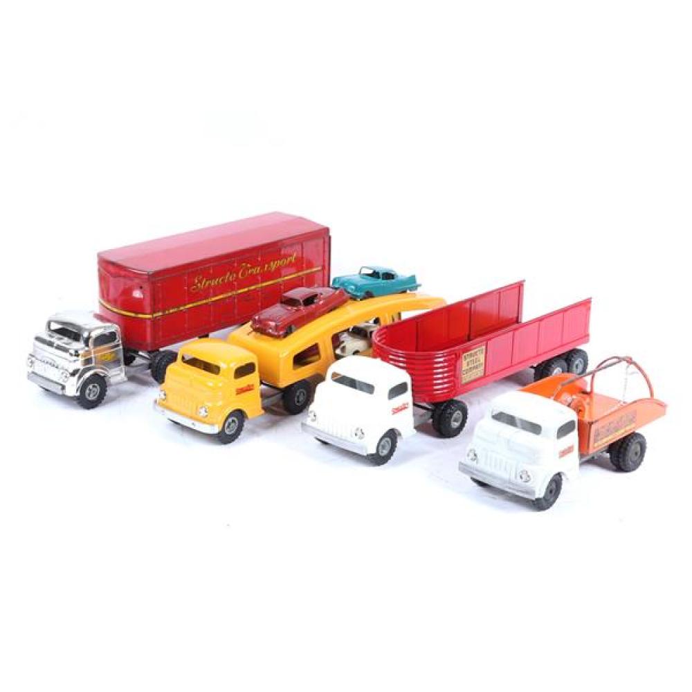 Appraisal: FOUR STRUCTO TOYS PRESSED STEEL TRUCKS AUTO TRANSPORT WITH FOUR