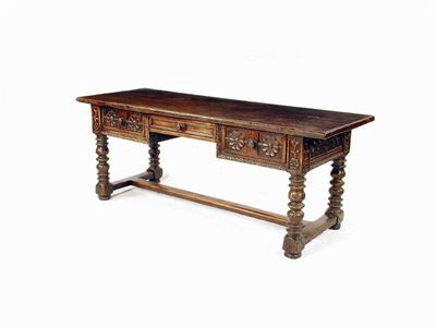 Appraisal: A Spanish chestnut kneehole centre table the one piece top