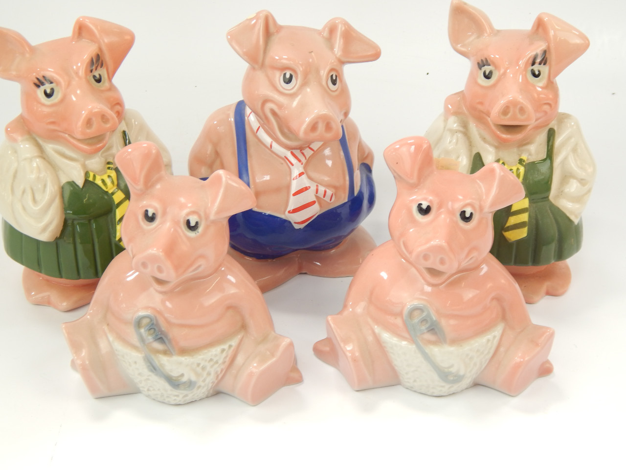 Appraisal: Wade Nat West piggy banks comprising Daddy two daughters and