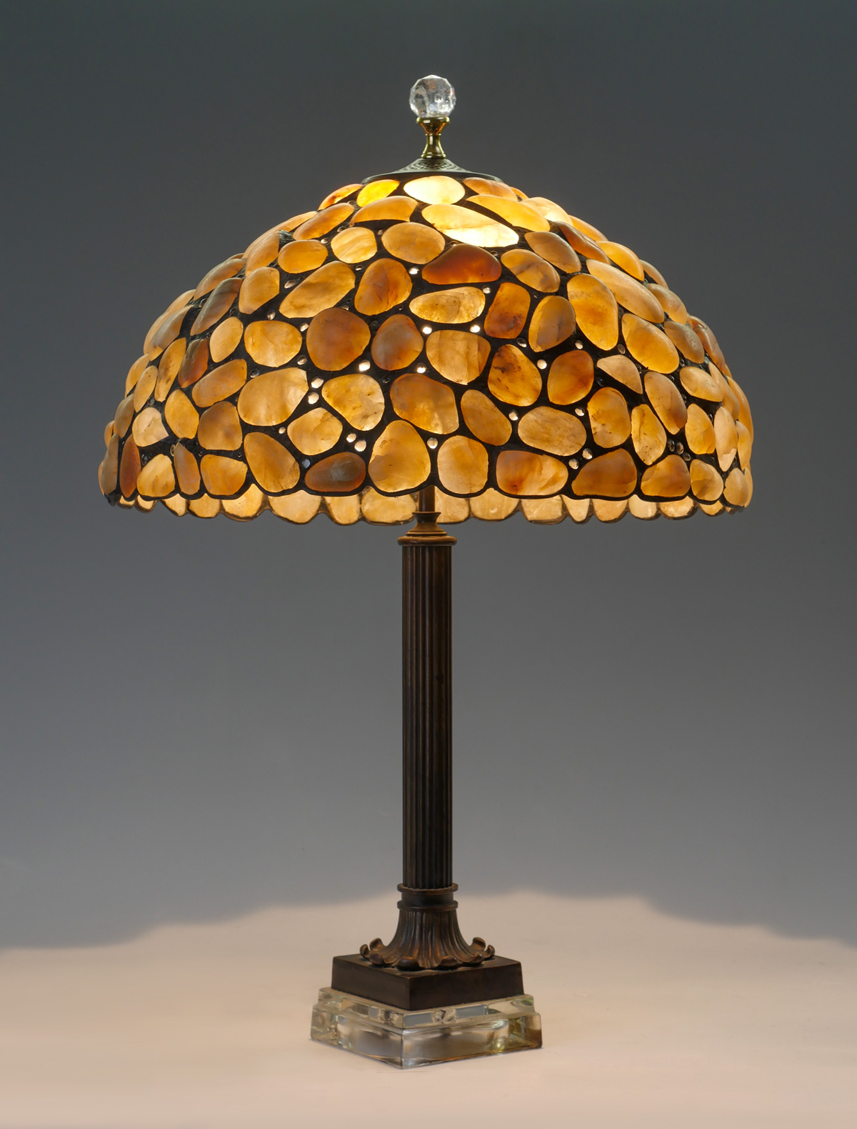 Appraisal: STONE INSET TABLE LAMP Surmounting multi-faceted glass finial over a