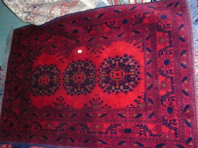 Appraisal: A SIMILAR TURKISH RED GROUND RUG with three central medallions