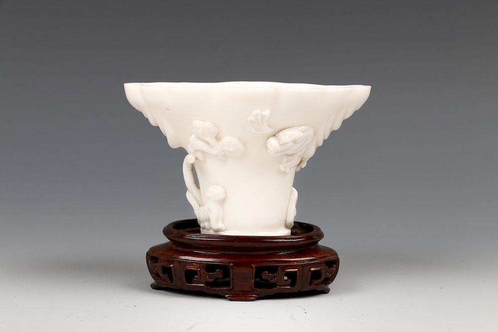 Appraisal: CHINESE BLANC-DE-CHINE LIBATION CUP WITH STAND Of a short cylinder