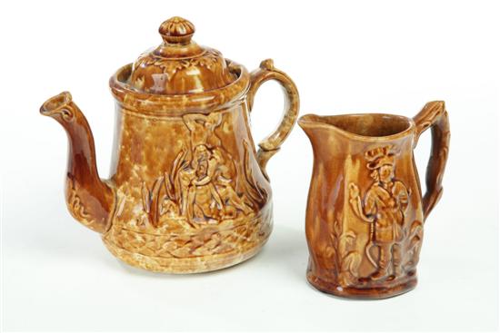 Appraisal: ROCKINGHAM PITCHER AND TEAPOT Small mottled glazed pitcher with image