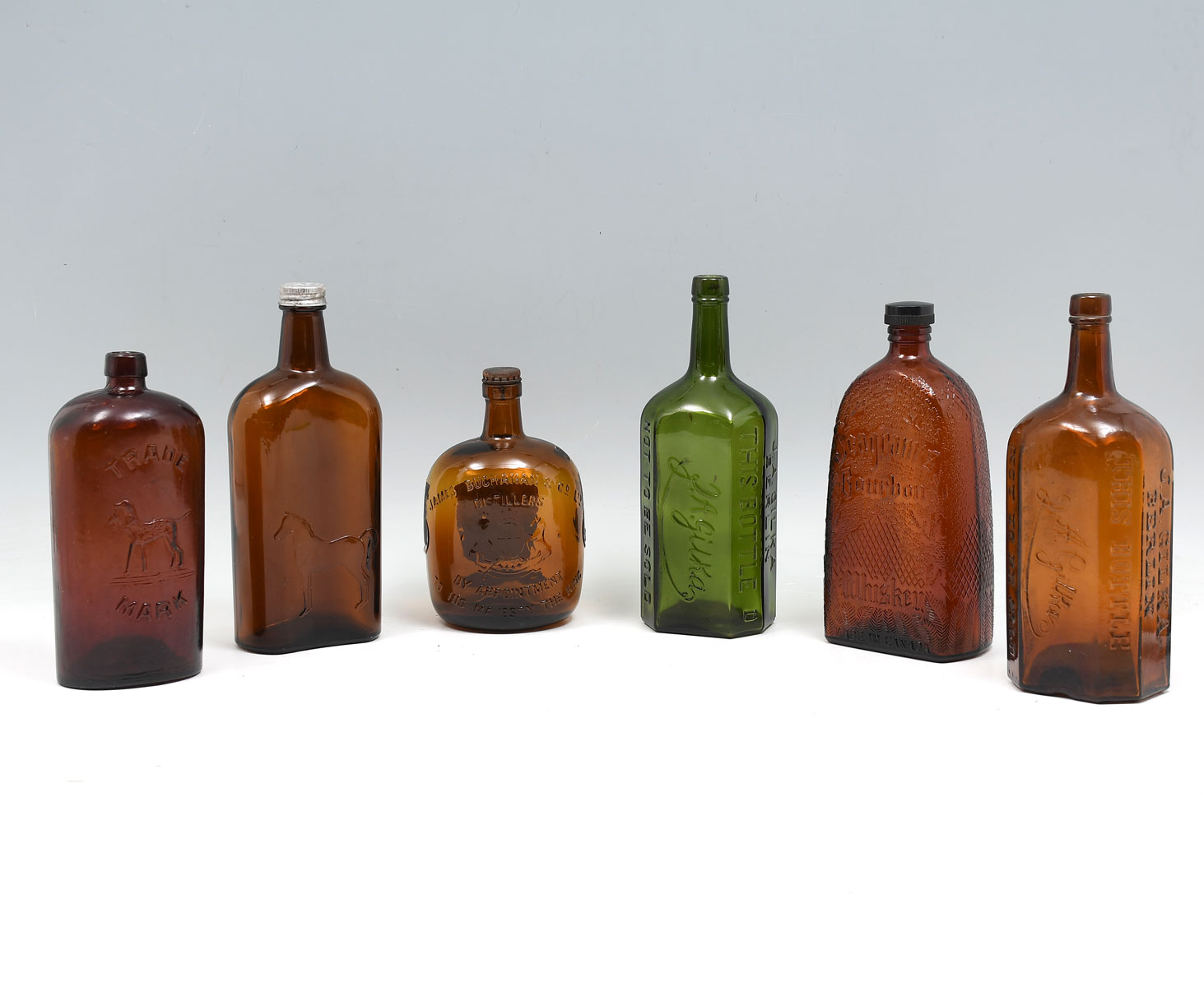 Appraisal: PC EARLY LIQUOR BOTTLES Comprising - early bottles having horses