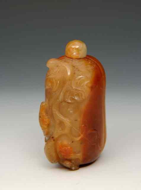 Appraisal: A CHINESE BROWN AND MUTTON FAT JADE SNUFF BOTTLE carved