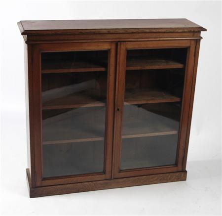 Appraisal: An early th century oak bookcase cabinet the chamfered rectangular