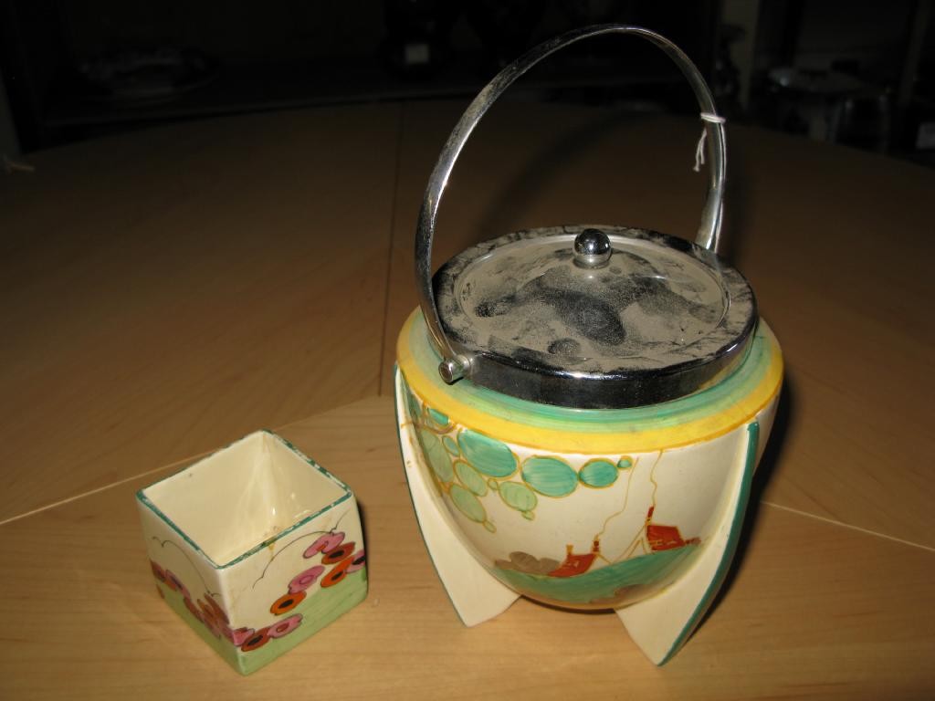 Appraisal: A Clarice Cliff biscuit barrel Secrets with chromium cover in