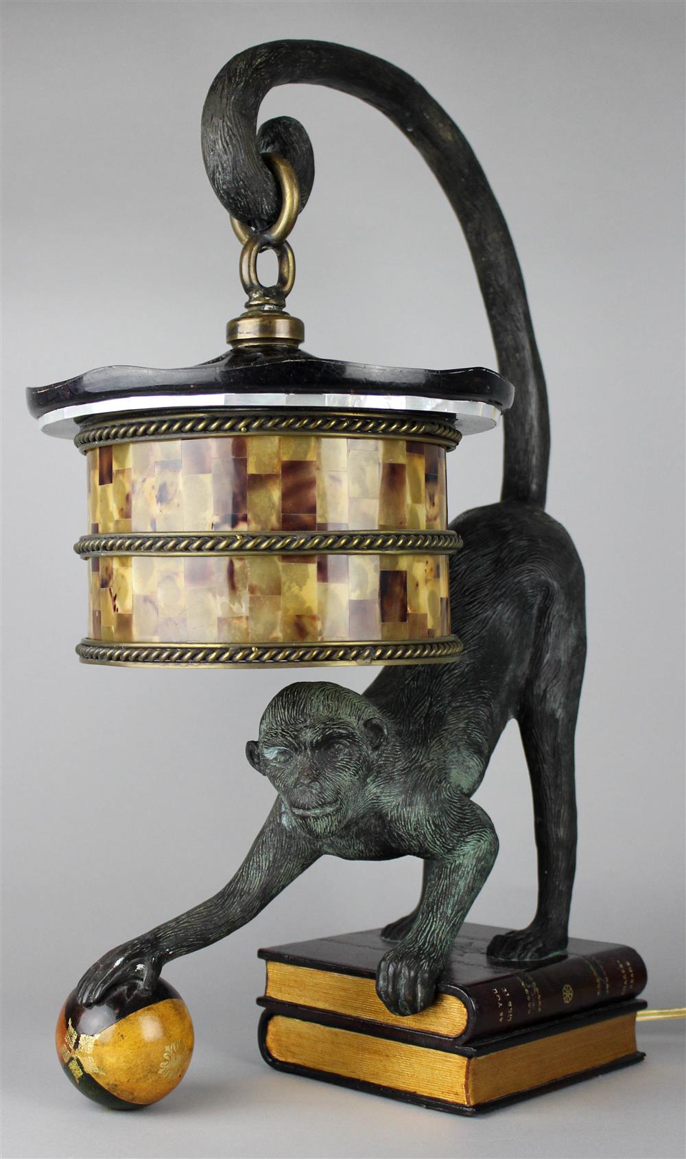 Appraisal: MAITLAND SMITH MONKEY WITH BALL ON BOOK LAMP cast metal