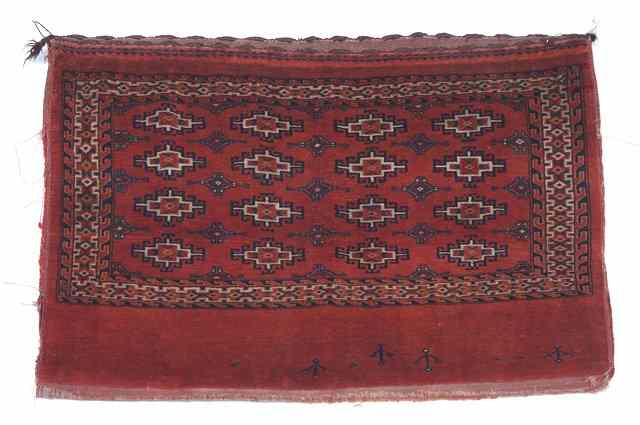 Appraisal: A TURKOMAN TENT BAG stylised guls and flat weave back