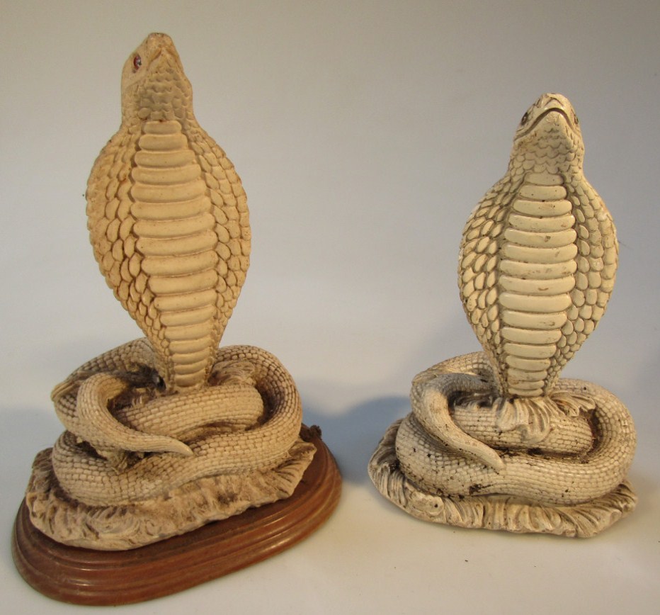 Appraisal: A near matching pair of Indian polished figures of cobras