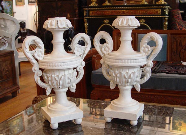 Appraisal: PAIR CARVED WOOD ARCHITECTURAL URNS White painted finish drilled as