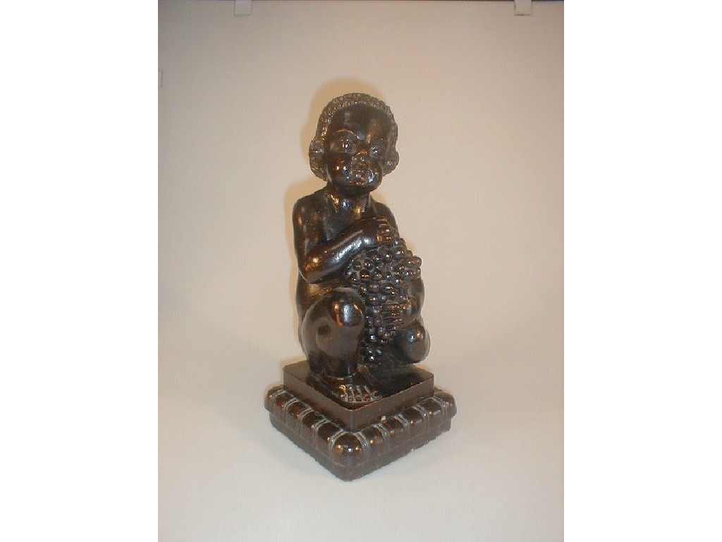 Appraisal: A Carved stained wood figure of a Bacchanite in a