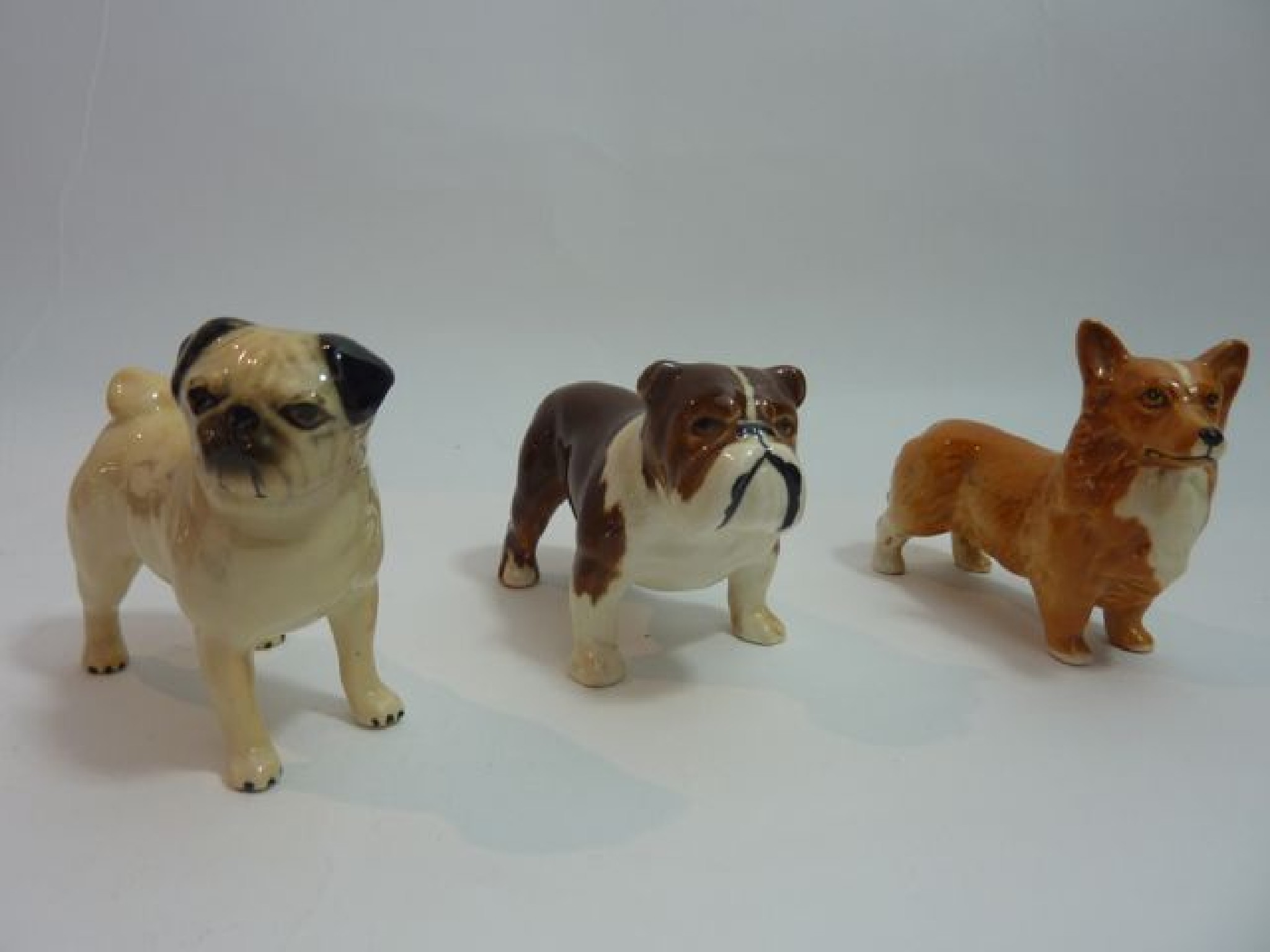 Appraisal: Three Beswick models of dogs comprising a Pug a Corgi