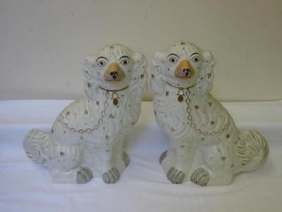 Appraisal: A PAIR OF STAFFORDSHIRE POTTERY SPANIELS modelled seated with gilt