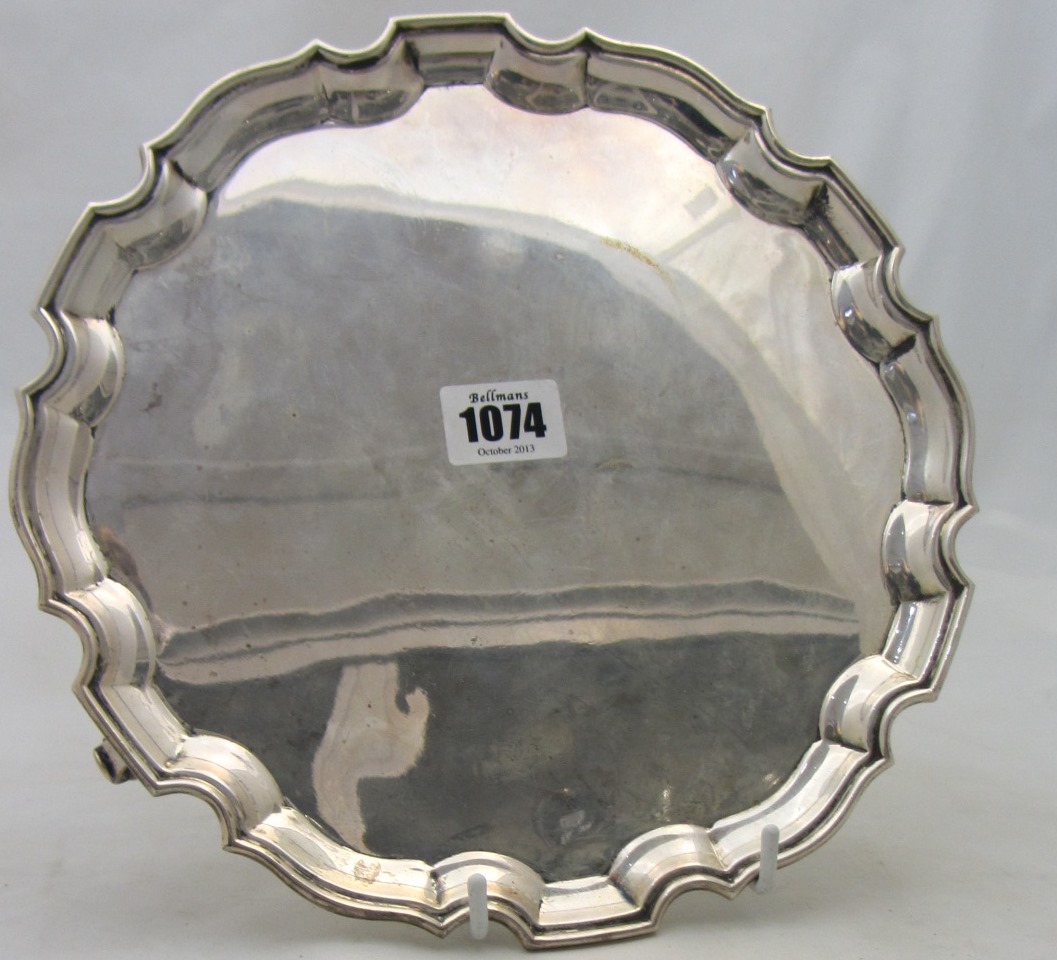 Appraisal: A silver salver of shaped circular form with a pie-crust