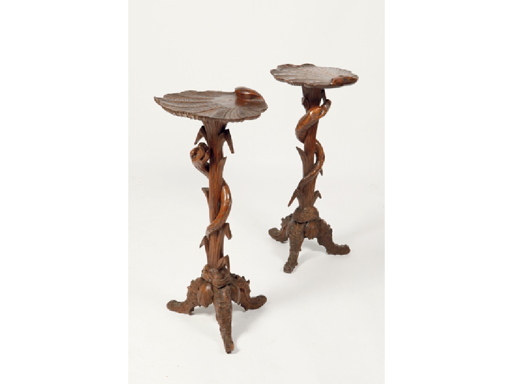 Appraisal: A PAIR OF BLACK FOREST GROTTO TORCHERES the tops carved