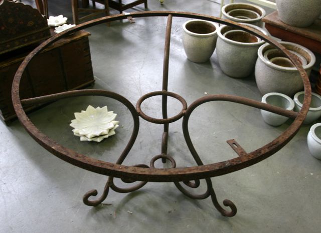 Appraisal: A cast iron garden table with circular glass top Contemporary