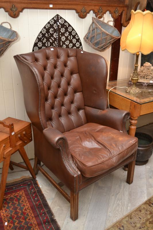 Appraisal: A CHESTERFIELD STYLE CHOCOLATE BROWN LEATHER SEMI-WINGBACK ARMCHAIR A CHESTERFIELD